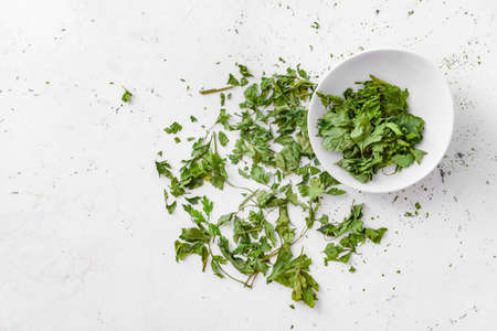 Plate with dry parsley on white backgroundの写真素材