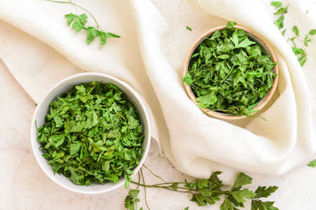 Bowls with dry parsley on tableの写真素材