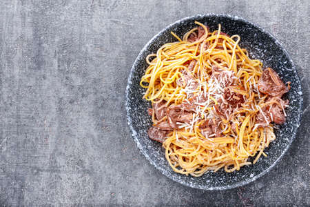 Plate with tasty pasta and mushrooms on dark backgroundの写真素材