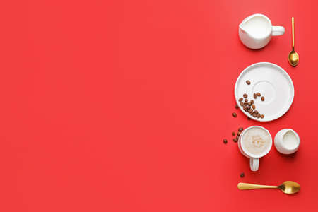 Cup of hot coffee with milk on color backgroundの写真素材