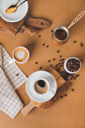 Cups of hot coffee on color backgroundの写真素材