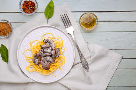 Plate with tasty pasta and mushrooms on tableの写真素材