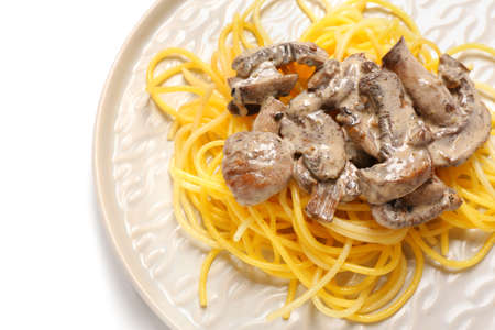 Plate with tasty pasta and mushrooms on white background, closeupの写真素材