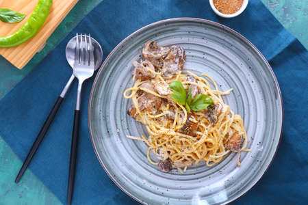 Plate with tasty pasta and mushrooms on tableの写真素材