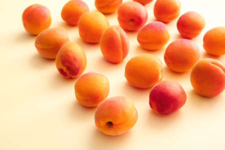Tasty ripe apricots on color backgroundの写真素材