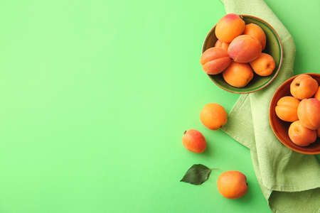 Tasty ripe apricots on color backgroundの写真素材