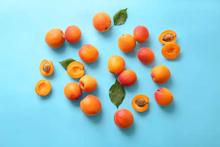 Tasty ripe apricots on color backgroundの写真素材