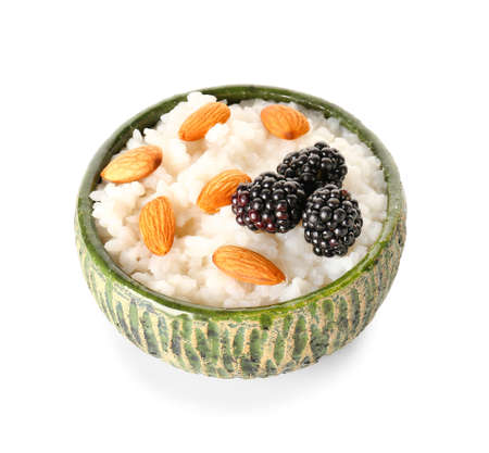 Bowl of tasty rice pudding with almonds and blackberry on white backgroundの写真素材