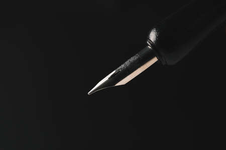 Fountain pen on dark backgroundの写真素材