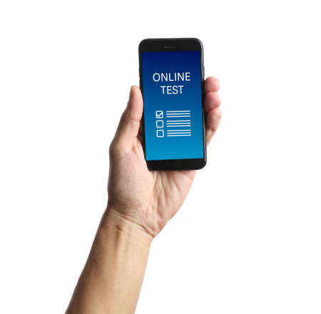 Male hand holding mobile phone with text ONLINE TEST against white background