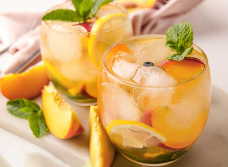 Peach cocktail in glasses on light backgroundの写真素材