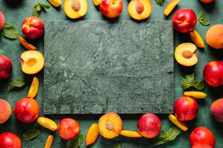 Frame made of sweet ripe peaches on dark backgroundの写真素材