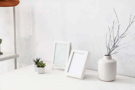 Photo frames on table in roomの写真素材
