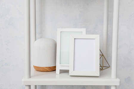 Photo frames on shelf in room