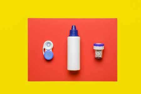 Containers with contact lenses and solution on color backgroundの写真素材