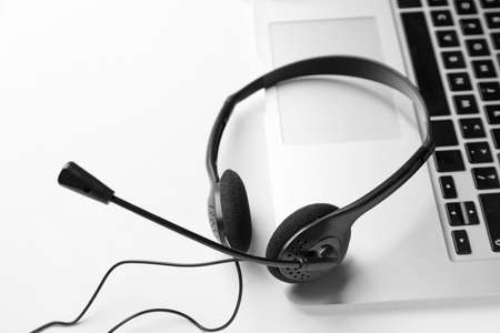 Headset with laptop on white backgroundの写真素材
