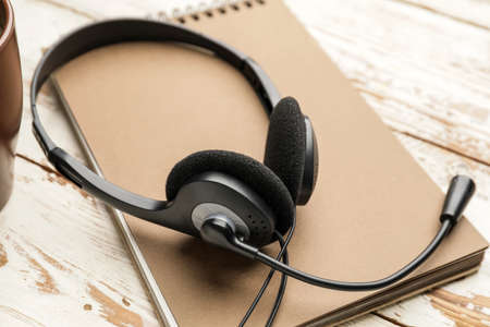 Headset with notebook on tableの写真素材