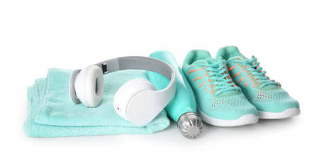 Sportive shoes, towel, bottle of water and headphones on white backgroundの写真素材