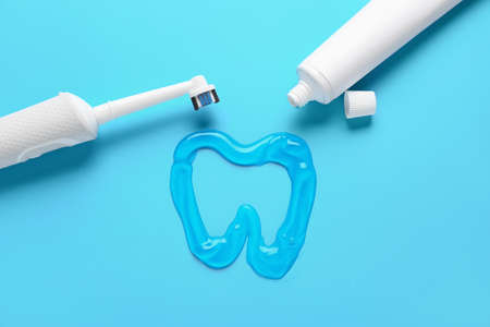 Electric tooth brush and paste on color backgroundの写真素材