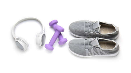 Sportive shoes, dumbbells and headphones on white backgroundの写真素材