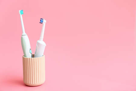 Electric tooth brushes on color background