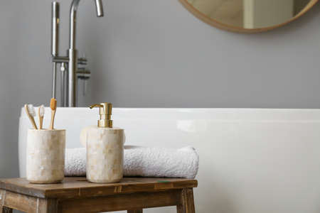 Soap and toothbrushes on table in interior of modern bathroom