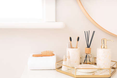 Soap with toothbrushes on table in bathroomの写真素材