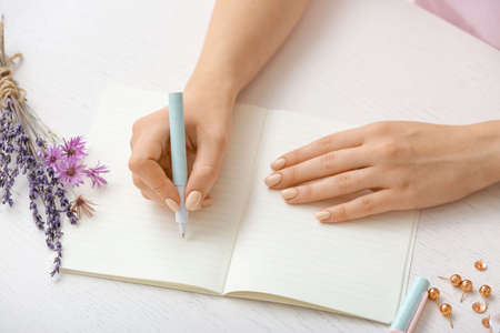 Woman writing in notebook with penの写真素材
