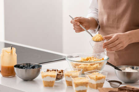Woman preparing delicious cupcake in jarの写真素材