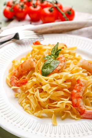 Plate of tasty pasta with shrimps on tableの写真素材