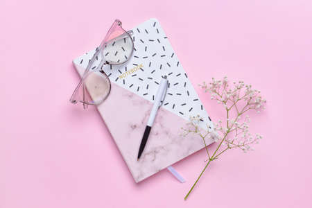 Notebook with pen on color backgroundの写真素材