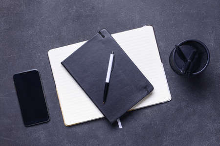 Notebooks with pen on dark backgroundの写真素材