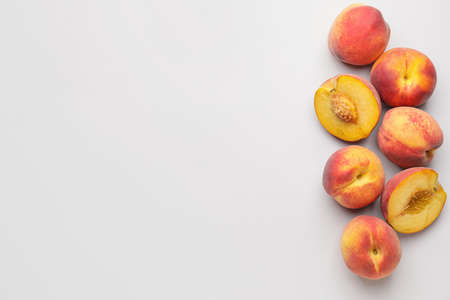 Many ripe peaches on light backgroundの写真素材