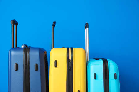 Packed suitcases near color wallの写真素材