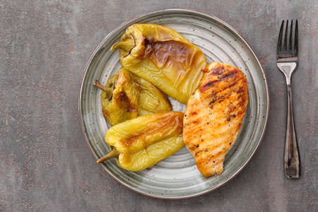 Plate with grilled bell peppers on dark tableの写真素材