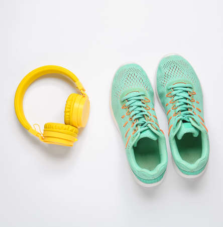 Sportive shoes and headphones on white backgroundの写真素材