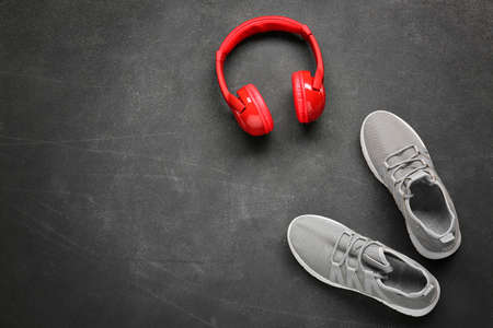 Sportive shoes and headphones on dark backgroundの写真素材