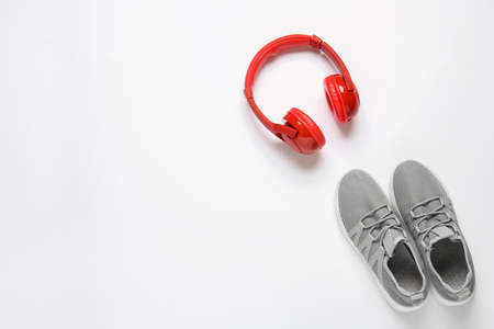 Sportive shoes and headphones on white backgroundの写真素材