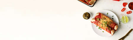 Plate with tasty cooked enchilada on white background with space for textの写真素材