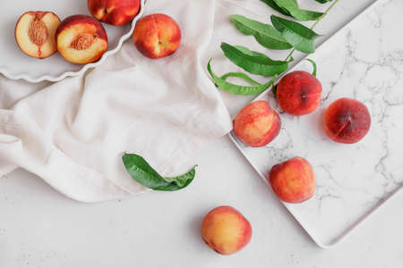 Tasty ripe peaches on white background