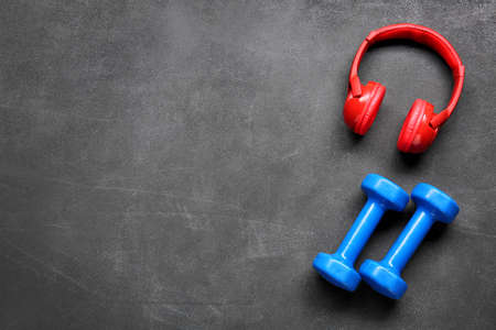 Dumbbells and headphones on gray backgroundの写真素材