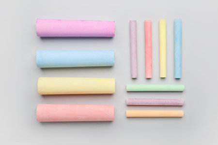 Composition with colorful chalks on color background