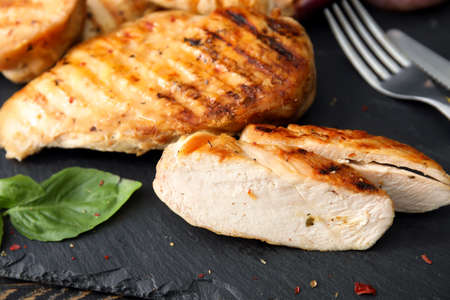 Cooked chicken fillet on dark tableの写真素材