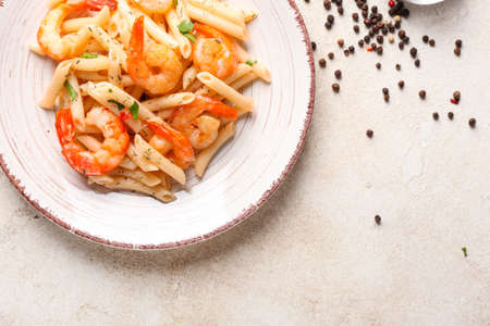 Plate of tasty pasta with shrimps on tableの写真素材