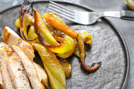 Baked pepper with chicken and spices on dark backgroundの写真素材