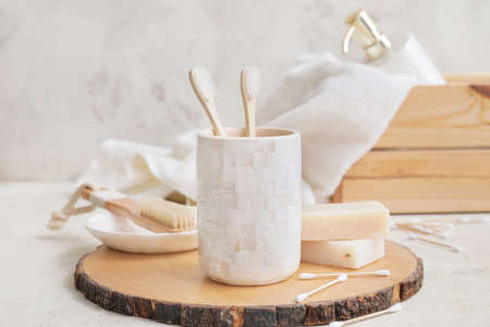 Wooden board with set of bath accessories on tableの写真素材