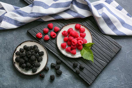 Tasty fresh berries on dark background