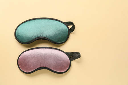 Sleep masks on color background