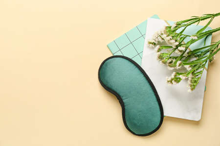 Sleep mask and flowers on color backgroundの写真素材