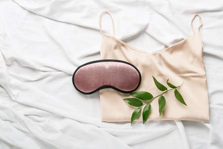 Sleep mask and pajamas on light backgroundの写真素材